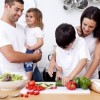 children_cooking_vegetables_with_parents-300x257
